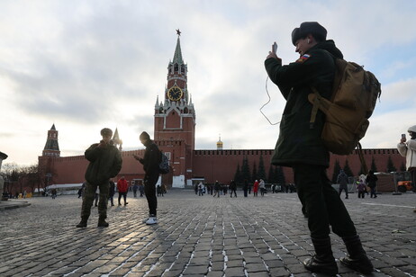 A Russian soldier uses his mobile phone on Red Square outside the Kremlin in Moscow